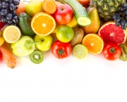 A pile of fresh, healthy fruits and vegetables on white.